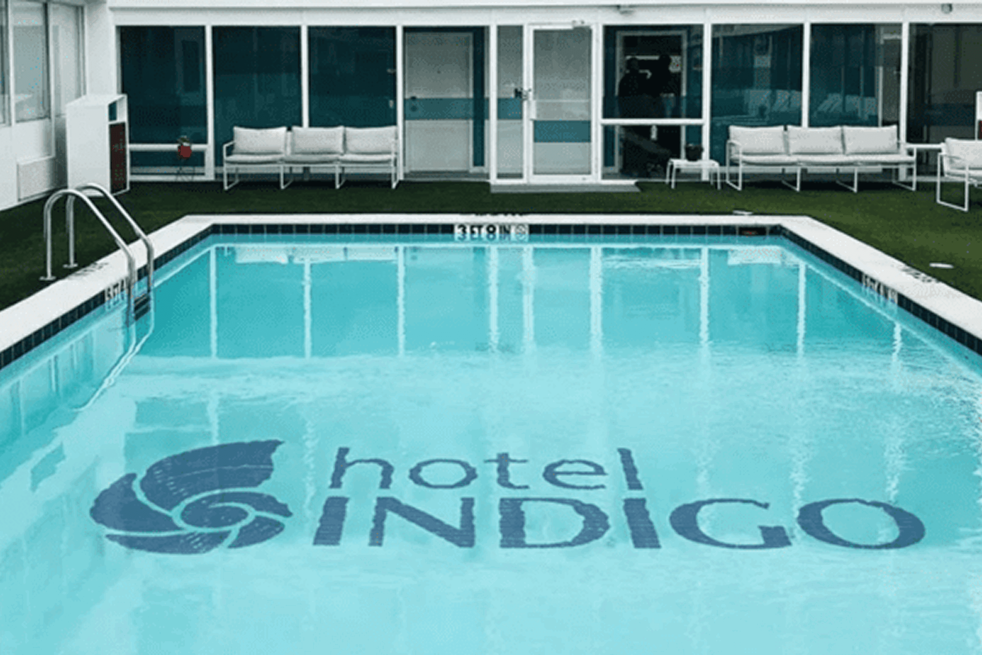 Clear pool water with Hotel Indigo logo at the bottom.